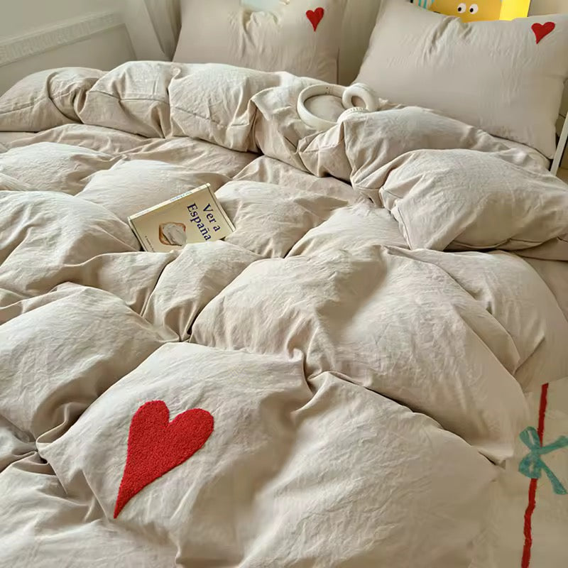 Full bed view of beige aesthetic bedding styled in a soft girl dorm setup