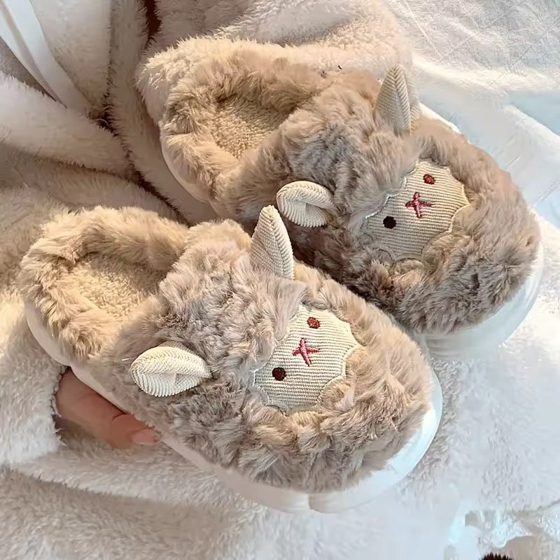 Pair of fluffy slippers with animal ears on a soft surface