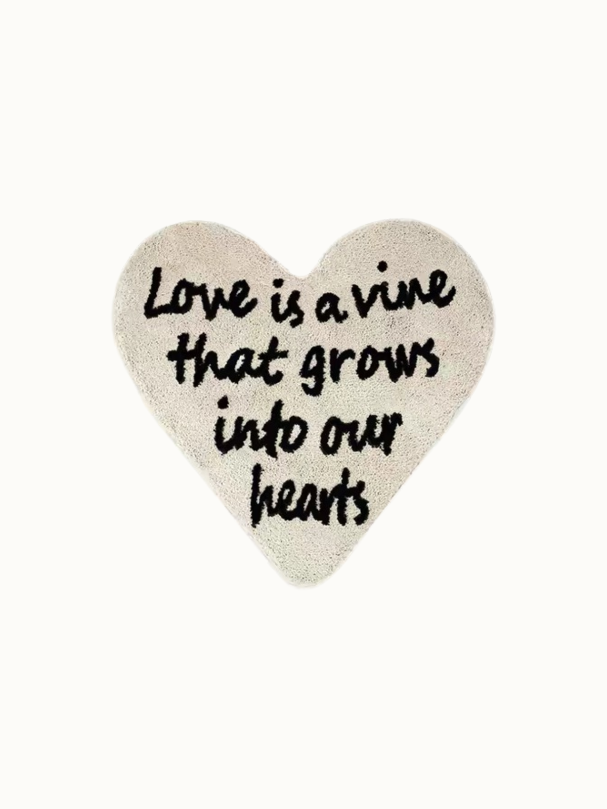 Cream typography rug shown against a plain background, with black love lettering inside the heart outline.