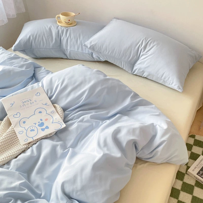 Aesthetic cream and blue bedding for dorm rooms and small bedrooms.