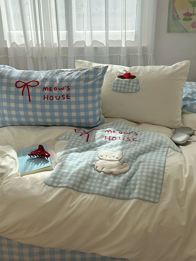 Blue checkered gingham pillow and cat quilt cover aesthetic setup.