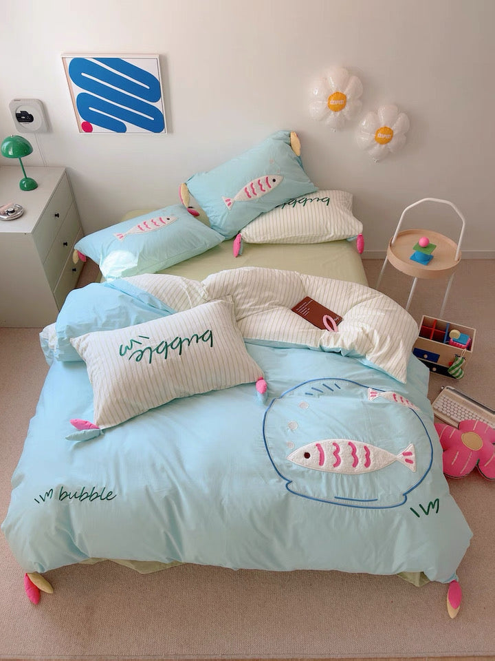 Close-up of hidden zipper and embroidery stitching on pastel cotton duvet cover.
