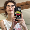 Person holding a phone with a cartoon tomato design