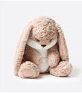 The bunny plush placed among other stuffed animals, standing out with its unique look.