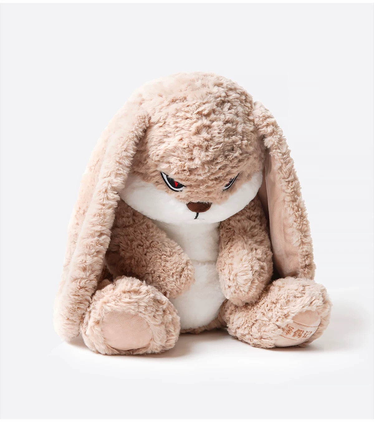 The bunny plush placed among other stuffed animals, standing out with its unique look.