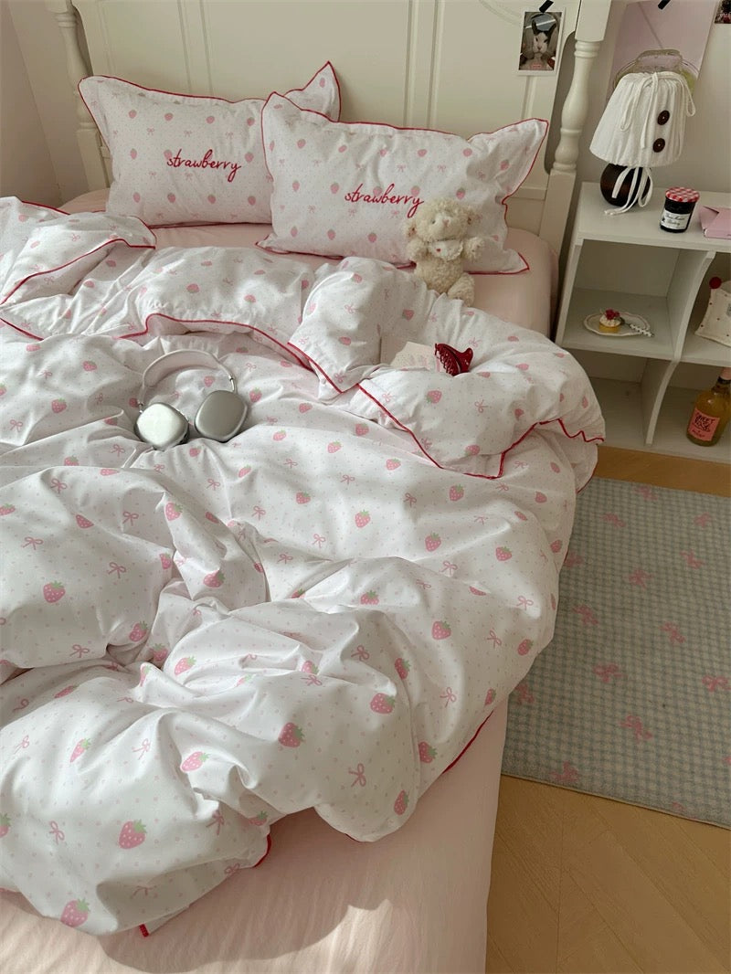 Bedding set with heart patterns on a bed in a room.