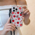 Person holding a phone case with strawberry pattern
