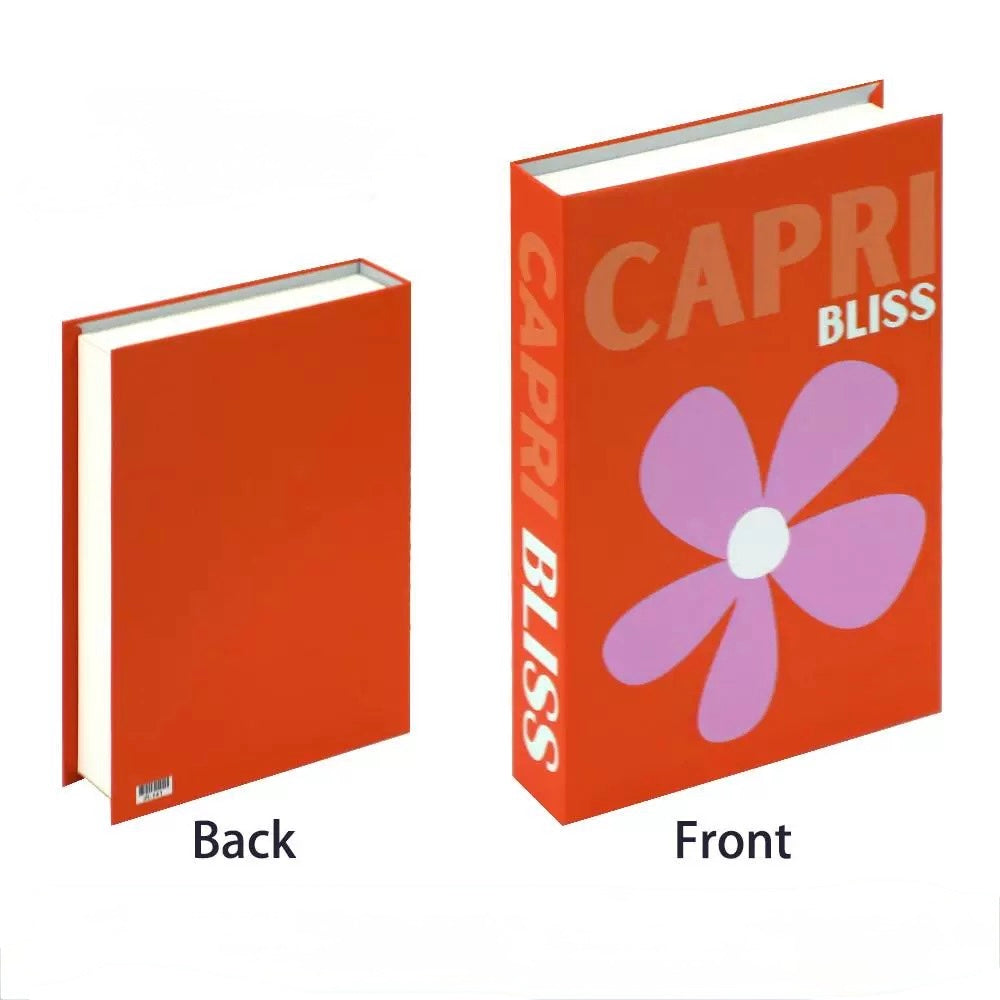 Faux book decor with text "Tropicana Suites" styled against a white wall with plants.