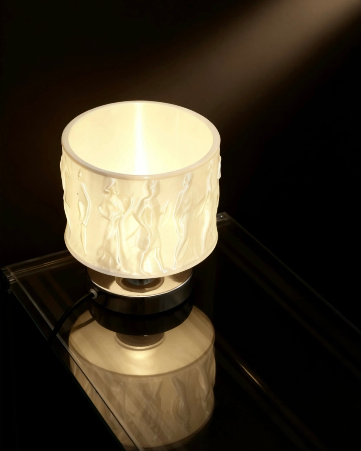 Decorative relief art table lamp placed on bedside table with warm eye protecting glow