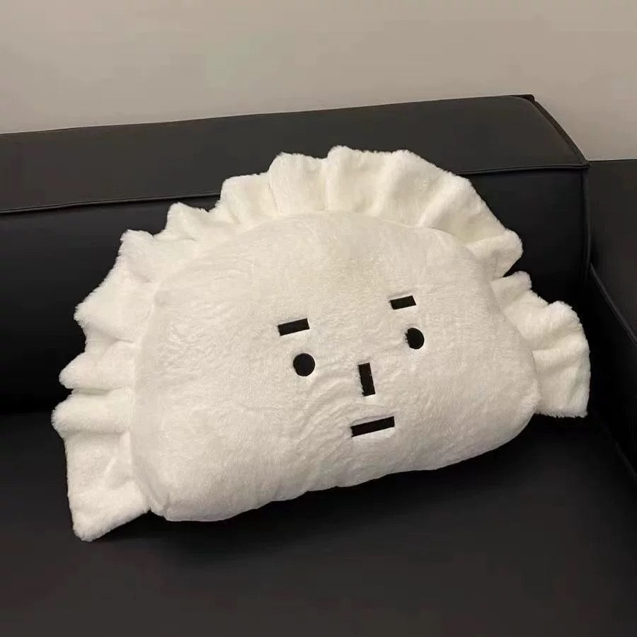 White plush toy with a face on a black surface