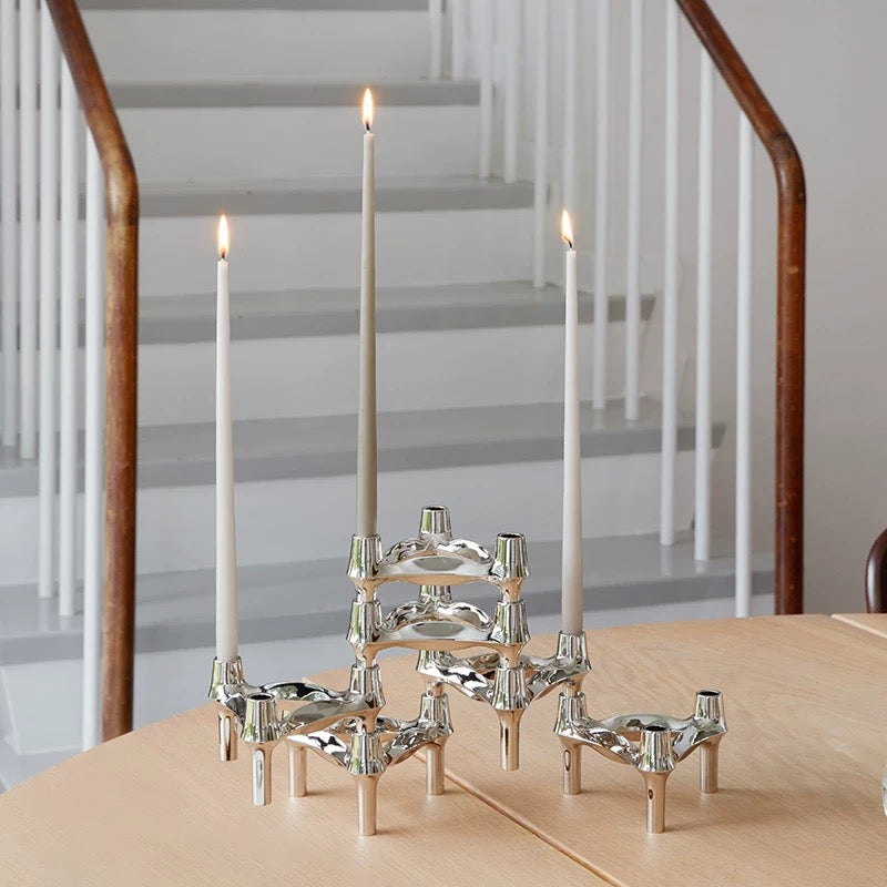 The candle holder in a minimalist bedroom setting, adding sophistication.