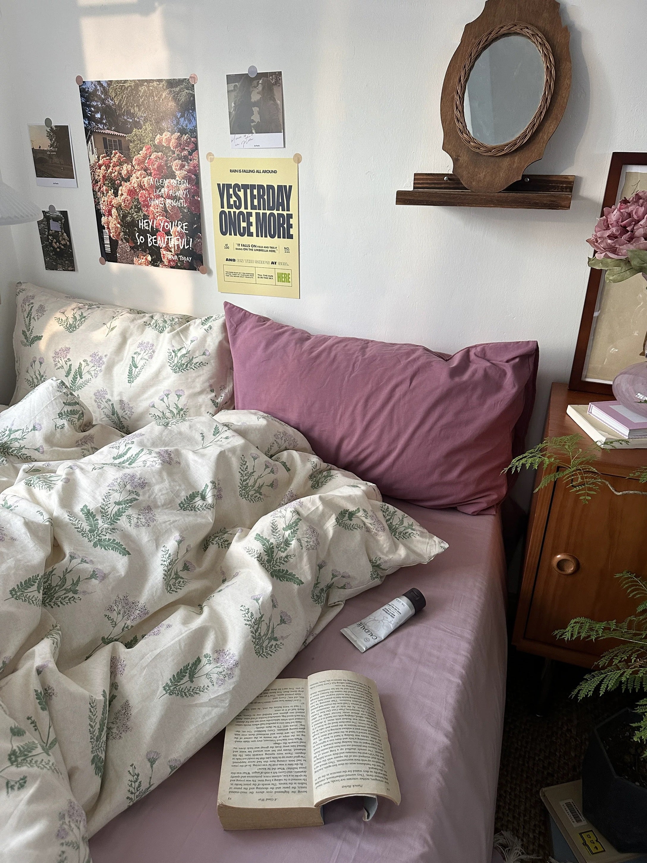 Vintage floral cotton bedding styled beside wooden furniture creating warm inviting reading corner atmosphere naturally.