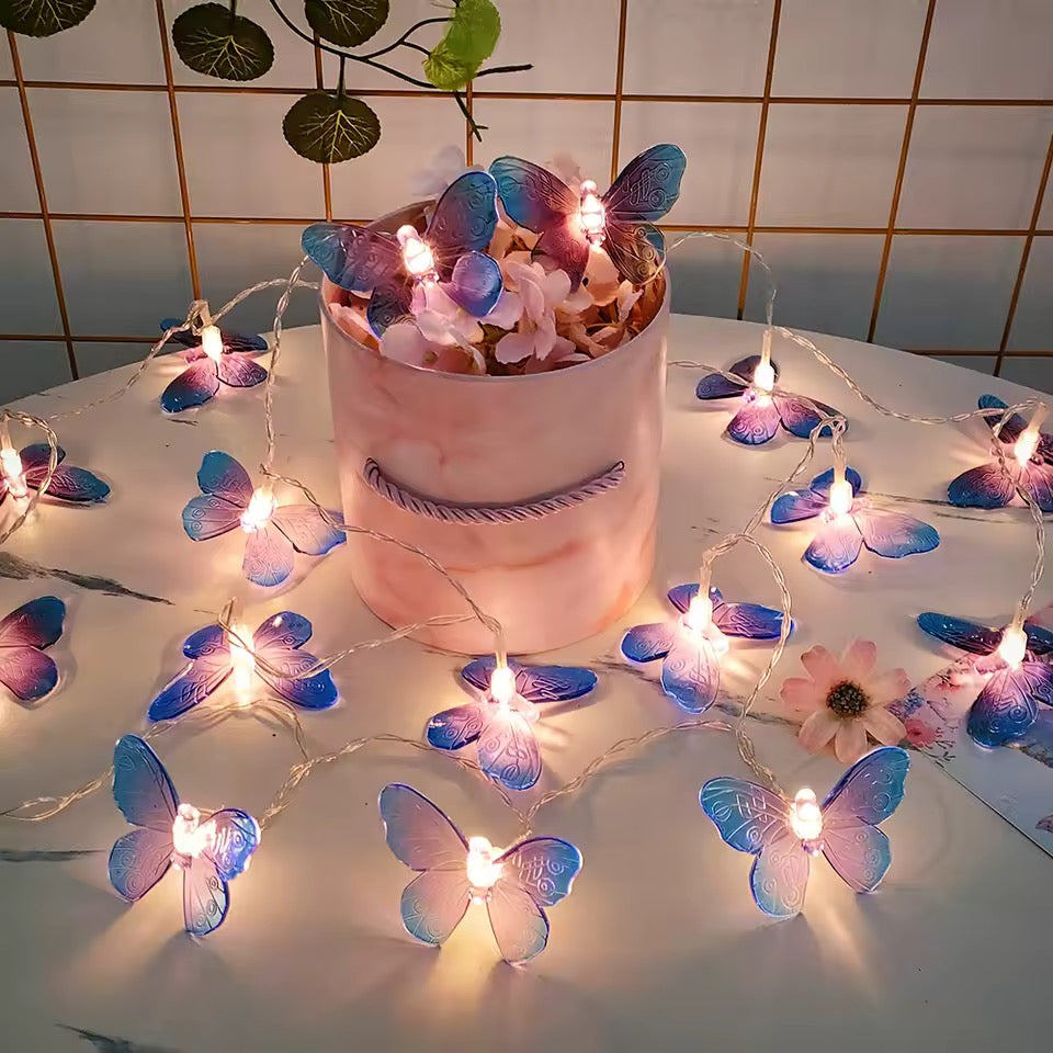 Butterfly string lights with a decorative pot of flowers on a tiled wall background