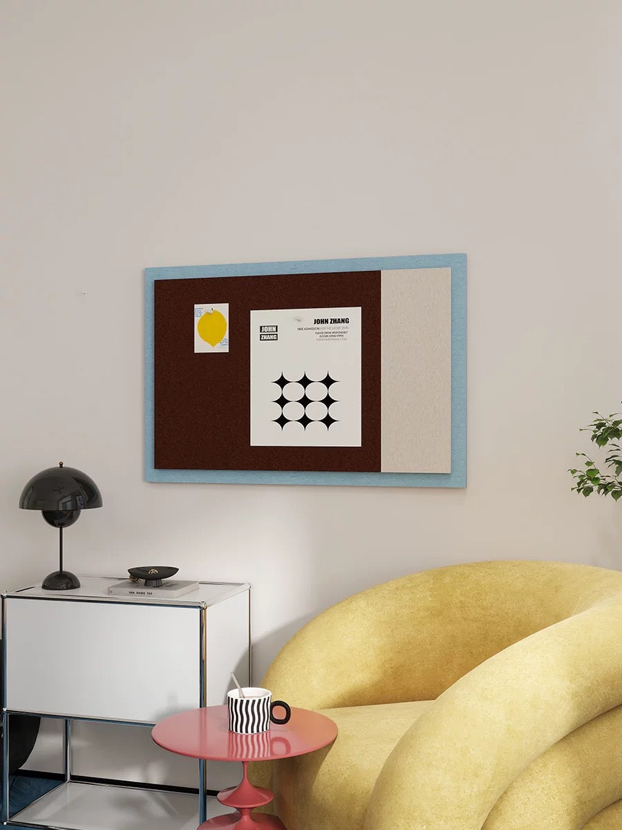 Bauhaus color block pin board displayed above a desk with a yellow sofa