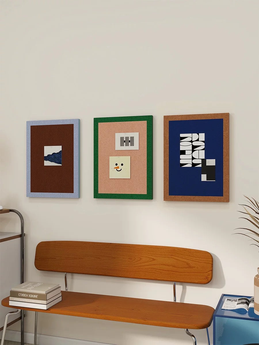 Three felt pin boards for wall display above a wooden bench.
