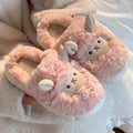 Pink fluffy slippers with bunny design on a soft white background