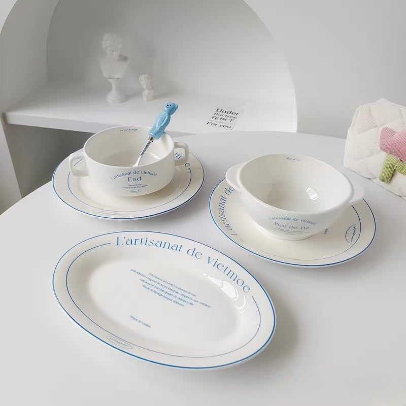 Round white ceramic French bistro plate with blue rim lettering shown directly from above clearly