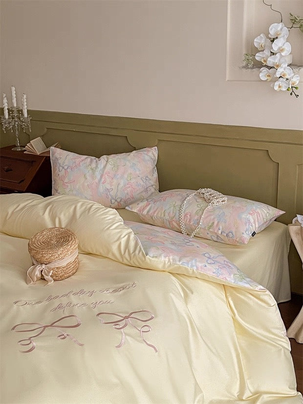 Neatly made bed with floral-patterned pillows and embroidered bedding in a bedroom setting.
