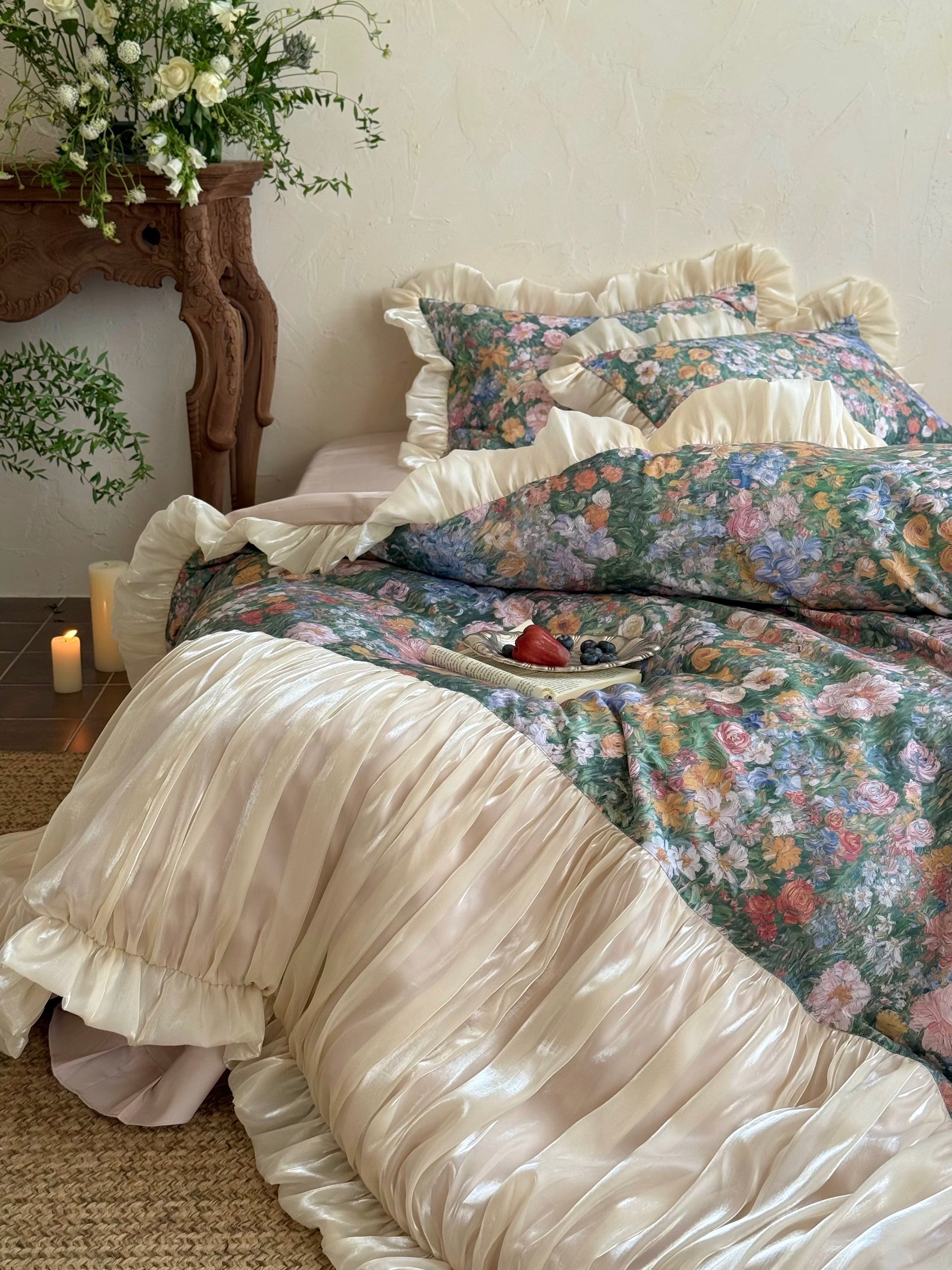 Floral bedding set with ruffled edges on a bed in a bedroom setting.
