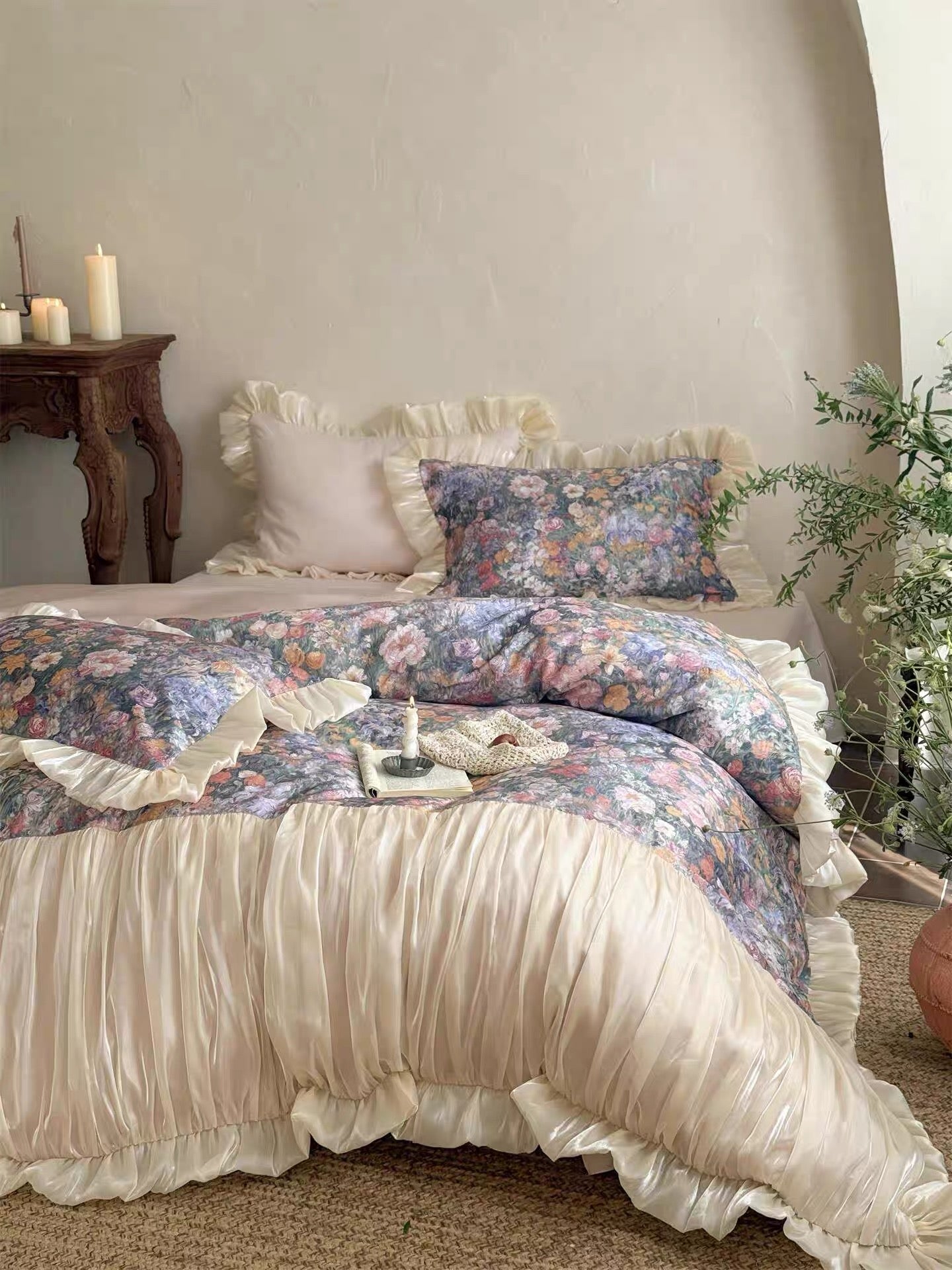 Floral bedding set on a bed with a side table and plant in the background