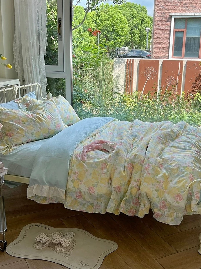 Cottagecore floral duvet cover beside a window overlooking a garden