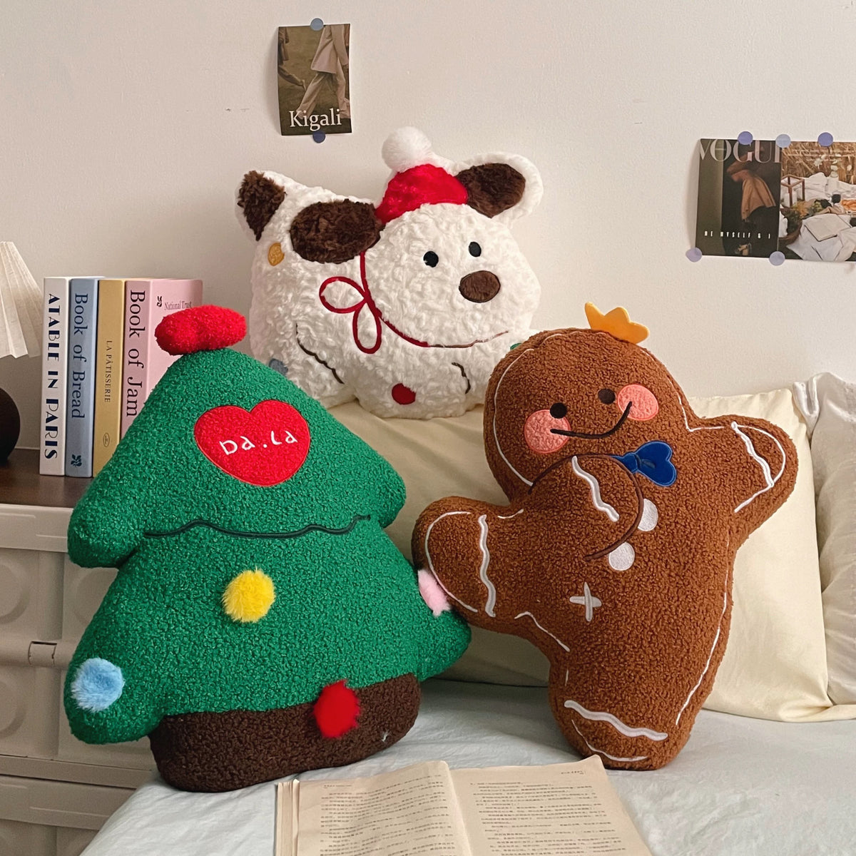 Christmas tree, gingerbread man and Santa puppy plush pillows arranged together on a sofa