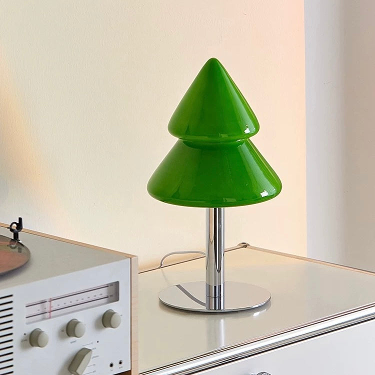 Green table lamp on a surface with a neutral background