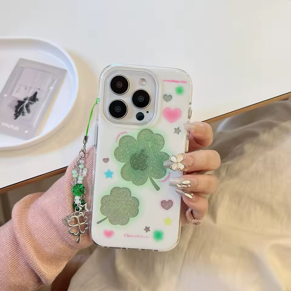 Phone case with four-leaf clover design on a light surface