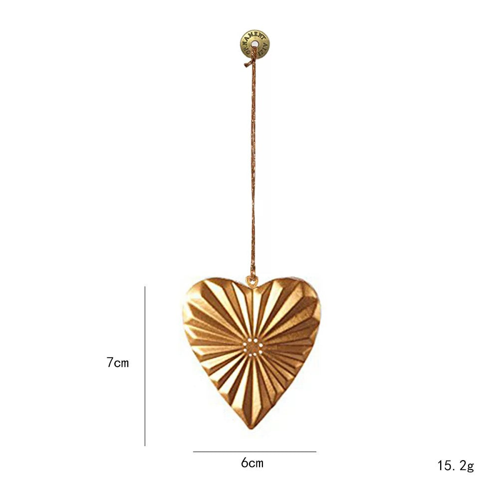 Gold metal Christmas ornaments include this heart with raised lines that fan outward from the center.