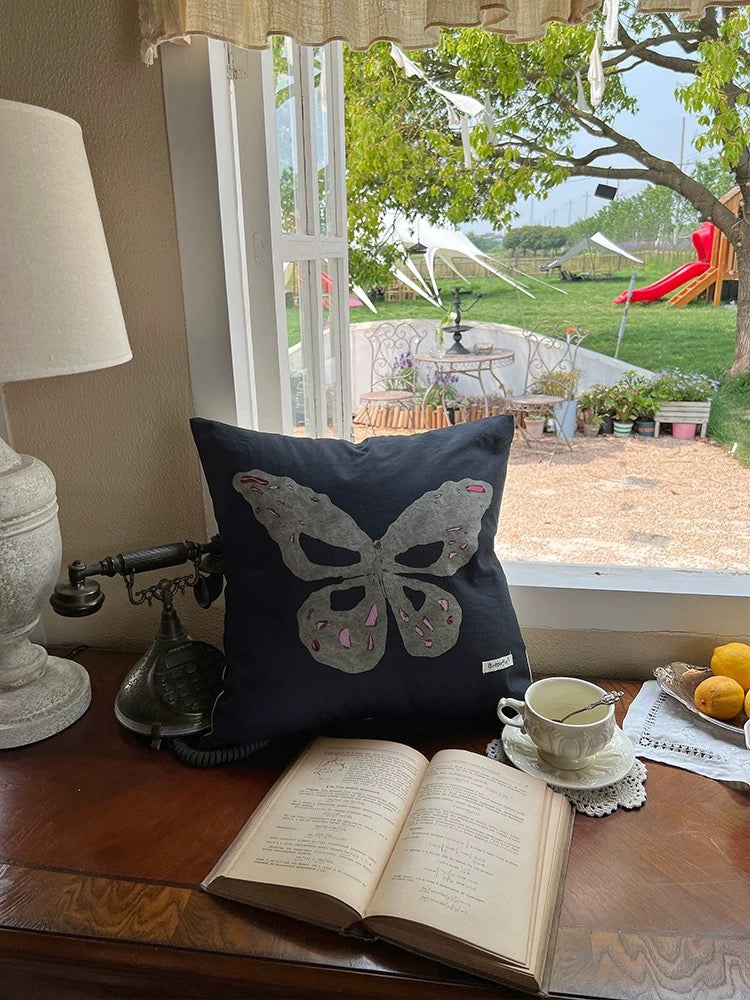 Gray butterfly oil painting throw pillow on deep navy cotton canvas