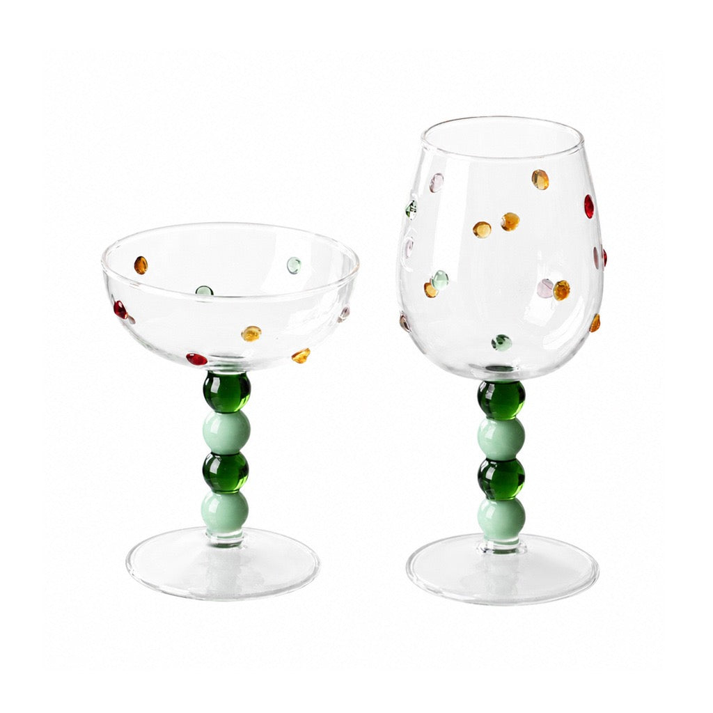 Green ball stem glasses in dessert cup and wine goblet shapes on white background