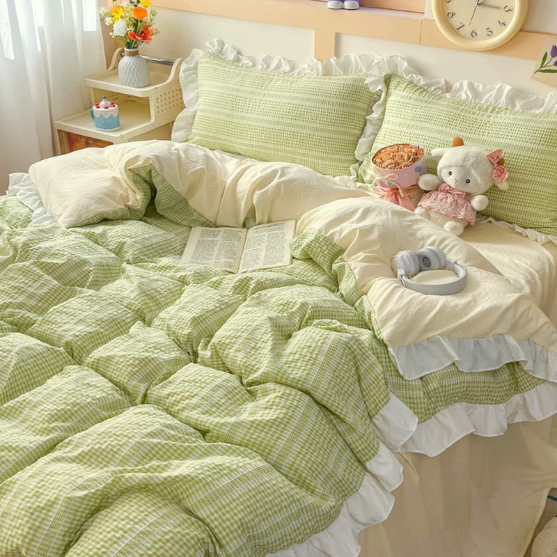 Bedroom with green and white bedding, stuffed animals, and a clock on the wall.