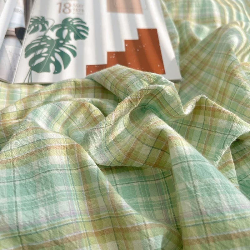 Close-up of green plaid fabric with a blurred background