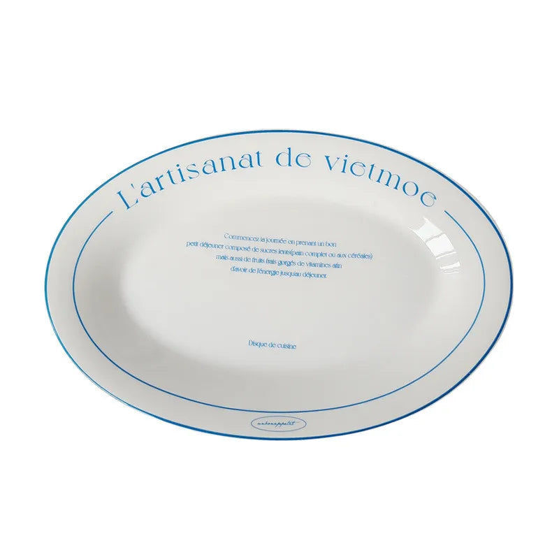 An oval white ceramic plate with blue printed text and border lines, shown on a white background with a size measurement label below reading 23*15*2.5cm.