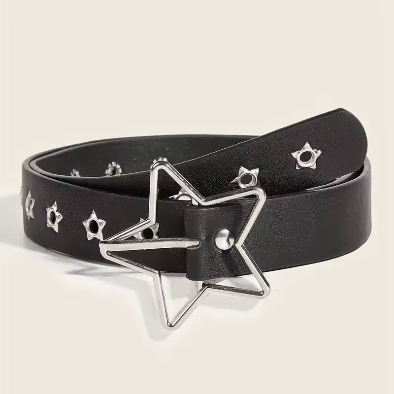 Person wearing a black belt with star designs on blue jeans.
