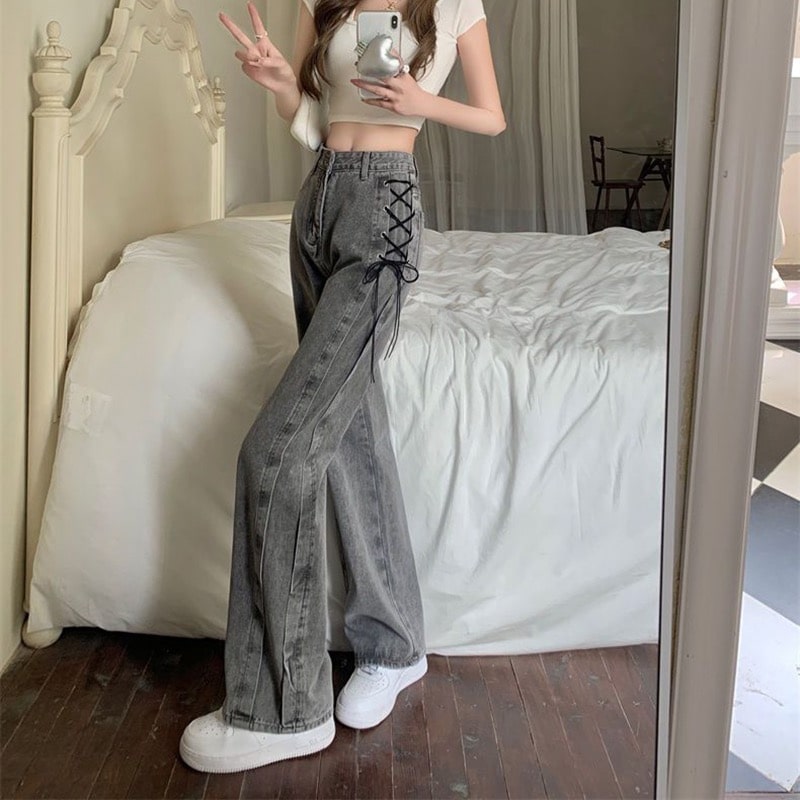 Vintage high-street denim pants with tie-up detail. Wide-leg smoke gray jeans for chic Y2K and retro-inspired fashion.