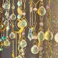 Rainbow-making sun catcher with moon and star design