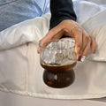 Durable wavy glass cup for coffee and beverages. Retro design ideal for aesthetic kitchen decor and daily use.