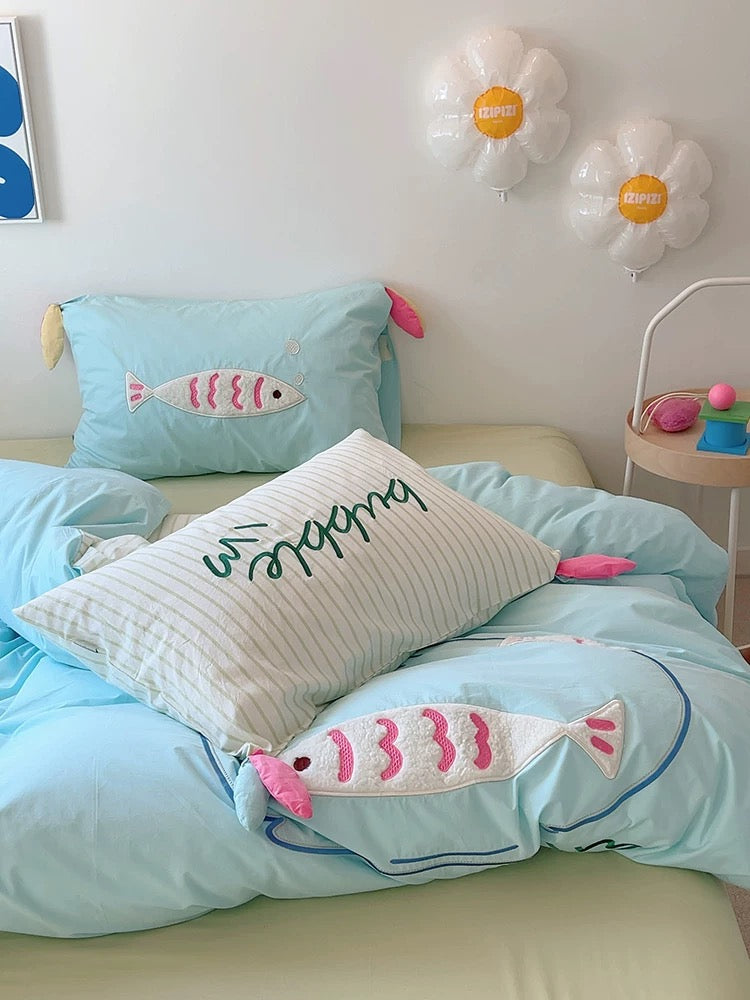 Close-up of hidden zipper and embroidery stitching on pastel cotton duvet cover.