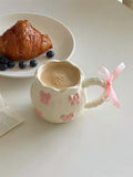 Pastel kitchen with pink ceramic cup in view