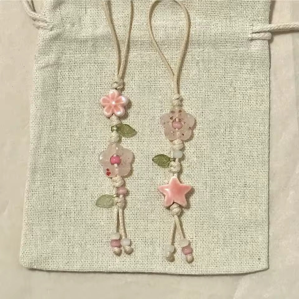Decorative bookmarks with floral designs on a textured fabric background