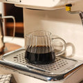 Stylish wavy glass cup with retro design. Perfect for breakfast milk, iced coffee, and cocktails in aesthetic kitchens.
