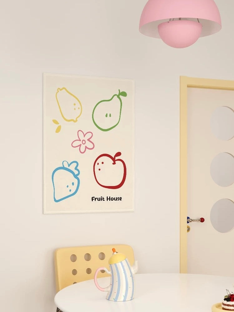 A cream fruit tapestry shows colorful fruit outlines and a pink flower above a small dining table.