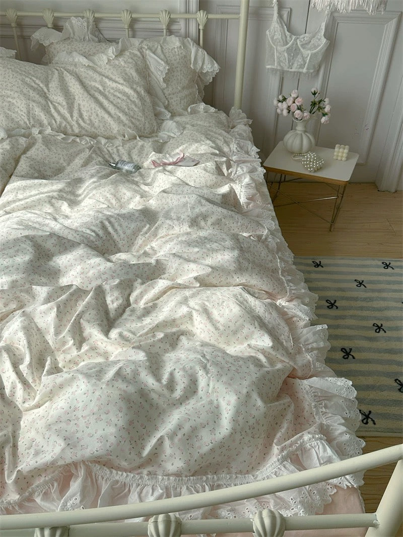 Bed with white floral bedding in a bedroom setting