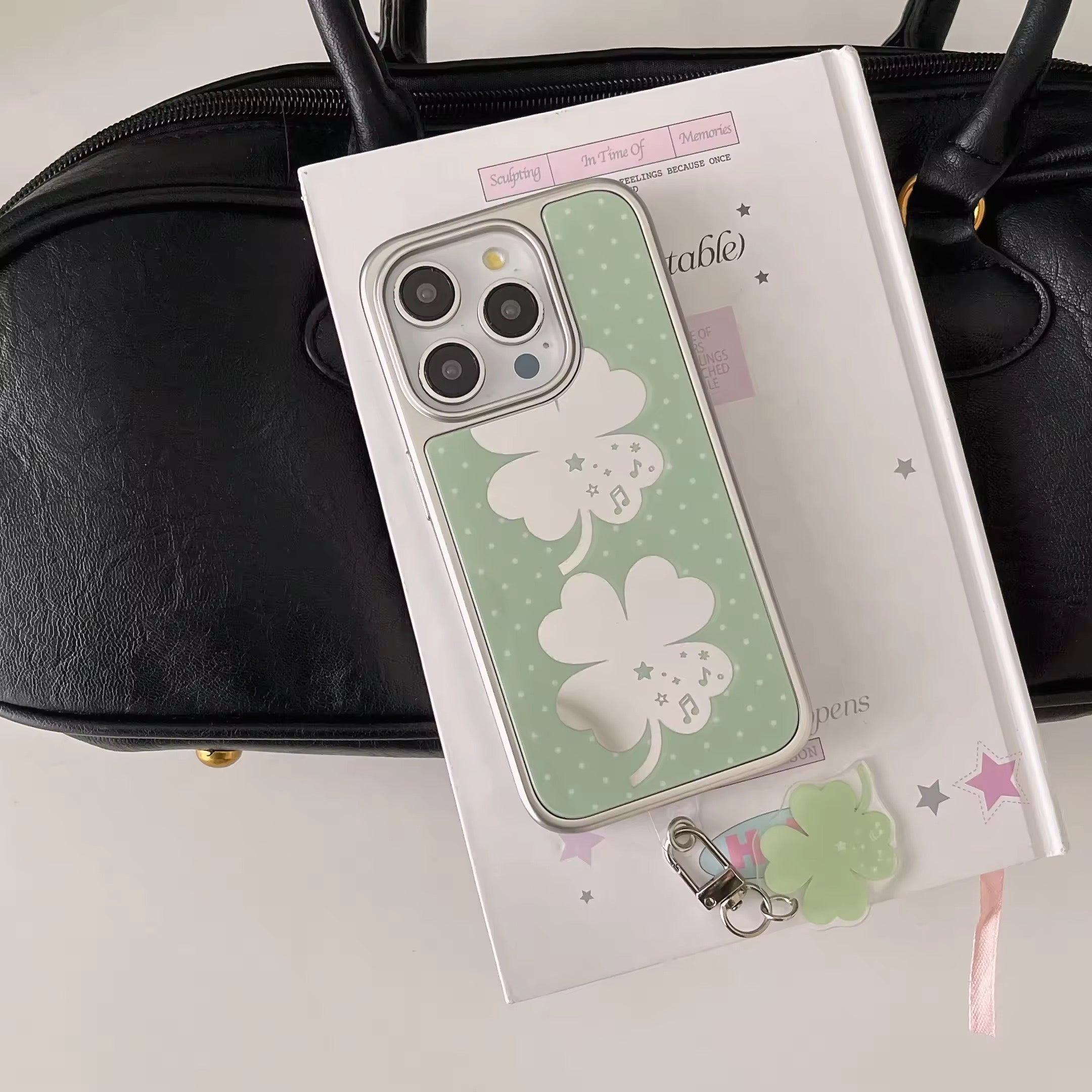 Soft girl aesthetic four-leaf clover iPhone case photographed on white background
