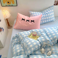 Overhead photo showing pastel bedding set with retro checked pattern and cute decor elements