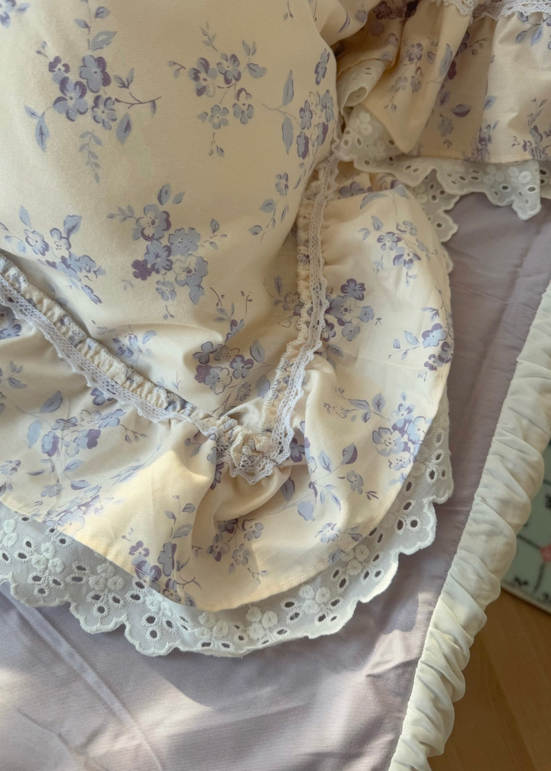 Floral-patterned headboard with lace trim on a bed