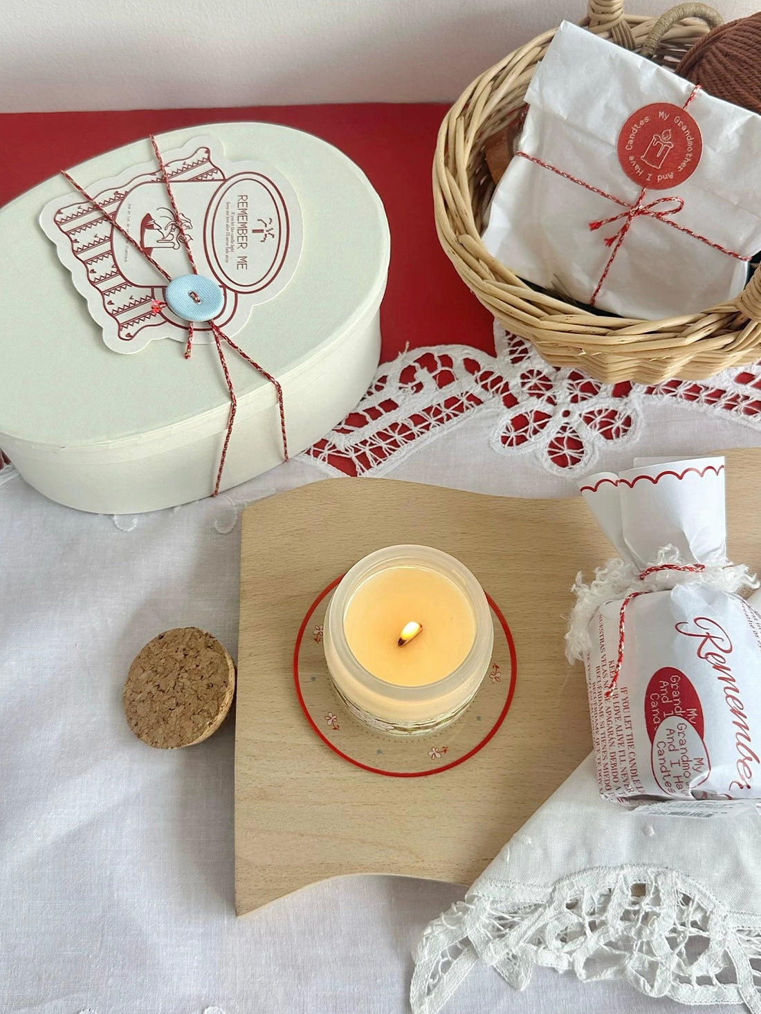 Wrapped Christmas scented candle held beside its gift packaging