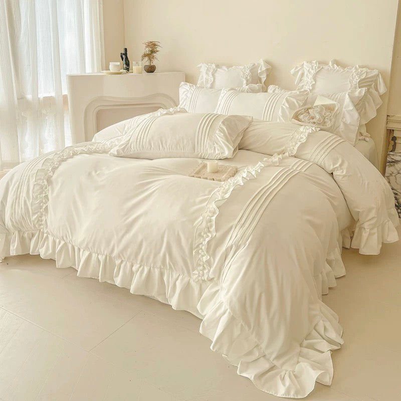 Neatly made bed with white bedding in a bedroom setting.