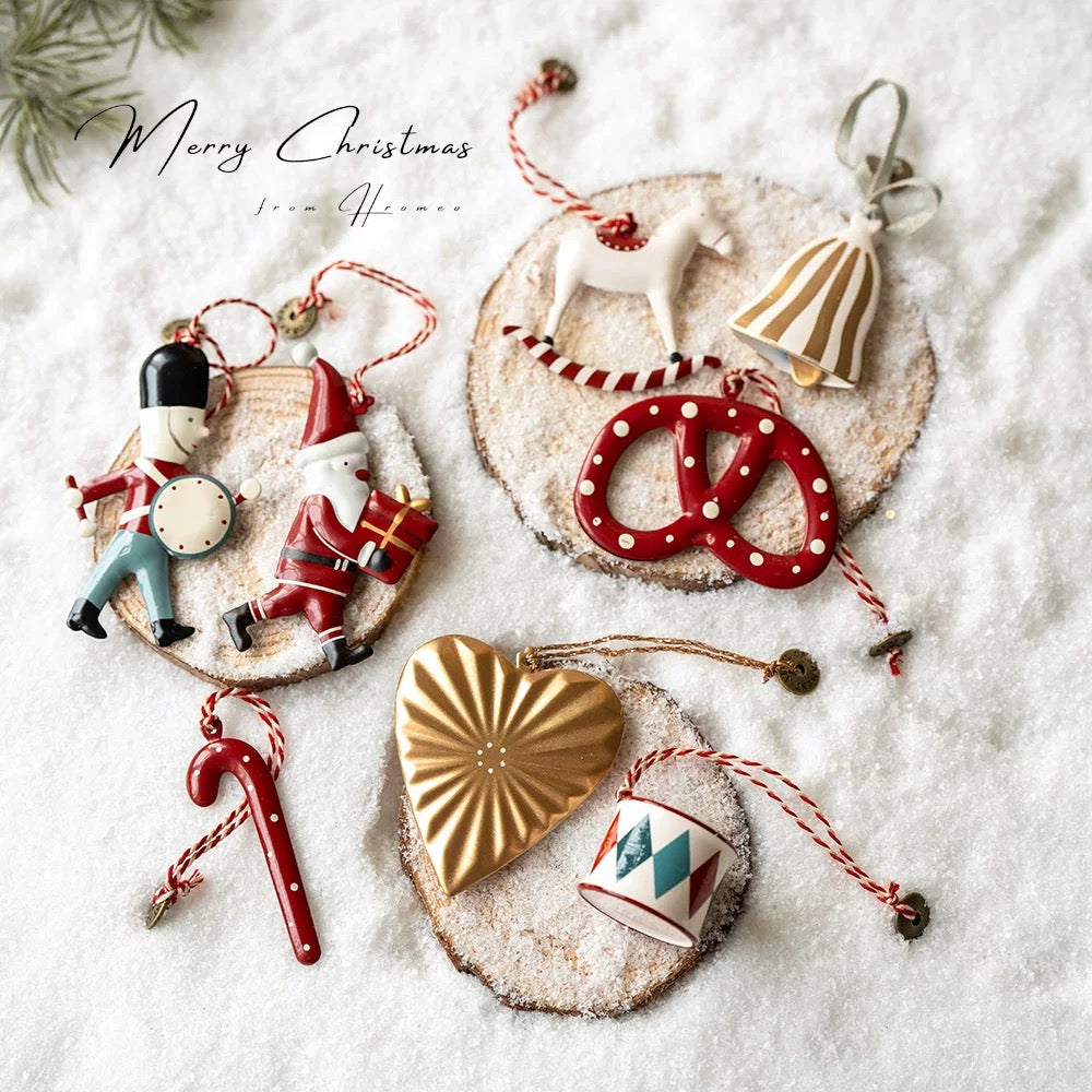 Metal Christmas ornaments include soldiers, rocking horses, a white dove, striped bells and a gold heart.